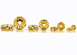 Vedere dettagli per Rulli metallici, color oro con pietre scintillanti Immagine di Rulli metallici, color oro con pietre scintillanti
